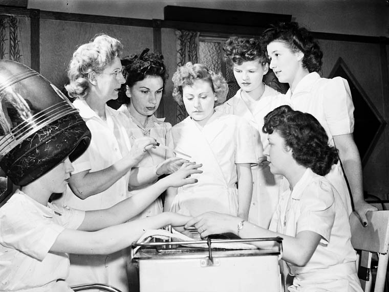 Ex-servicewomen learning manicure techniques during a retraining course on beauty parlour operation at the Robertson Hairdressing School, Apr 1945