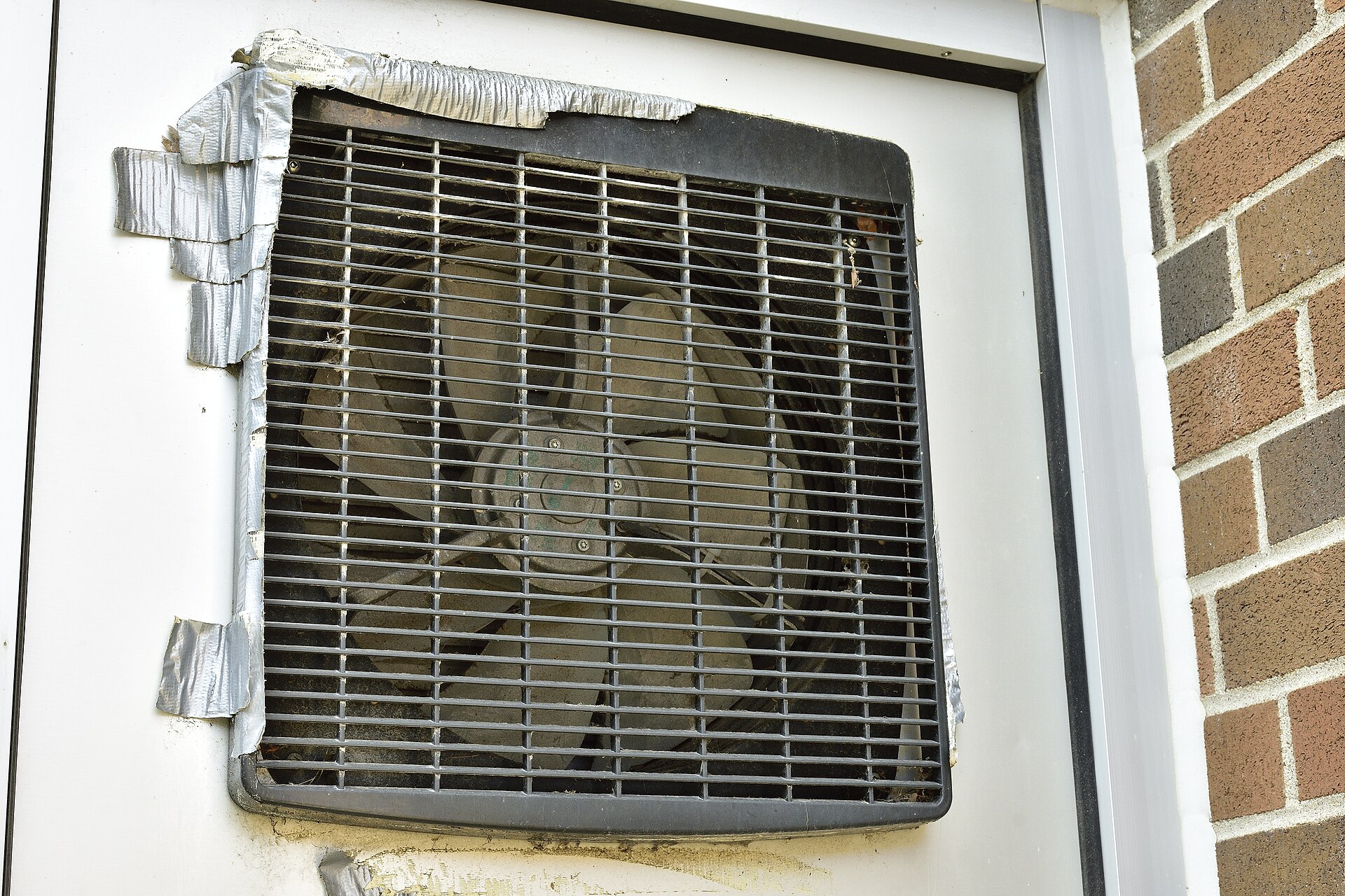 Exterior view of an Xpelair GX12 extractor fan. The seven blades, protective grille, and motor are visible.